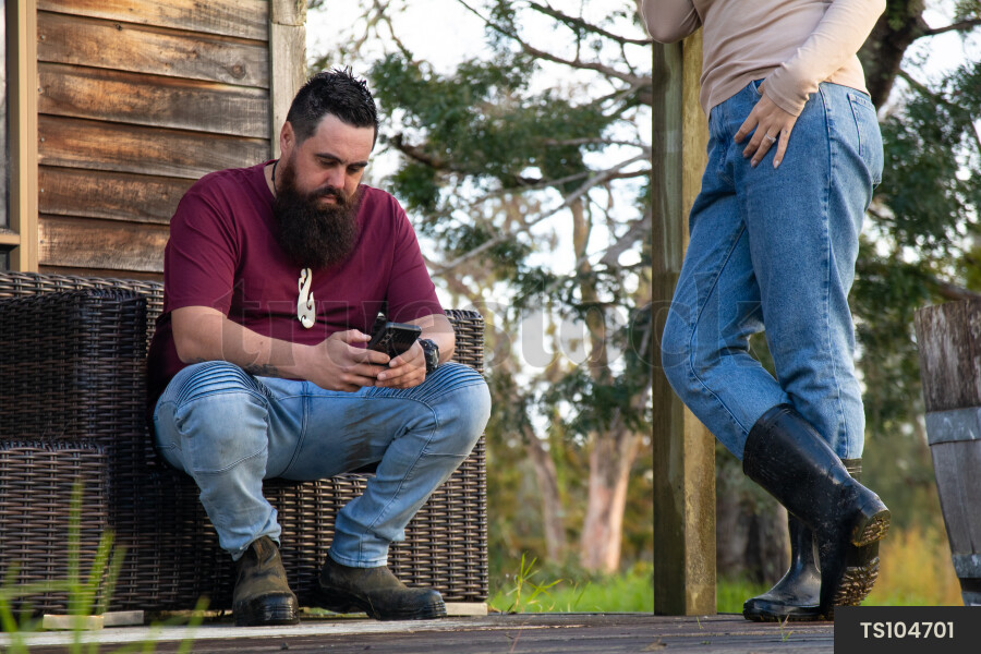 Family Using Phone on Deck