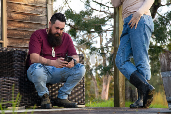 Family Using Phone on Deck