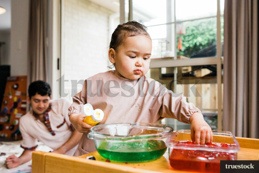 Baby playing with jelly