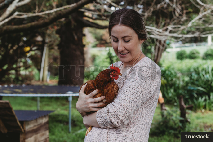 Lady carrying chicken