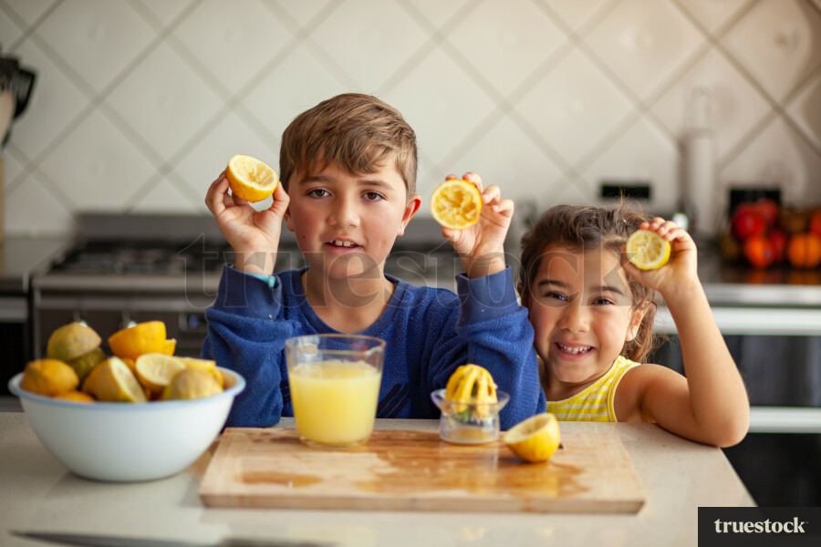 Young children making lemondade