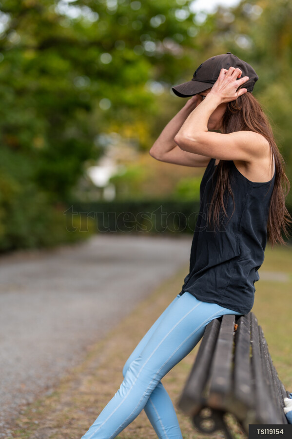 Woman sitting on bench in park