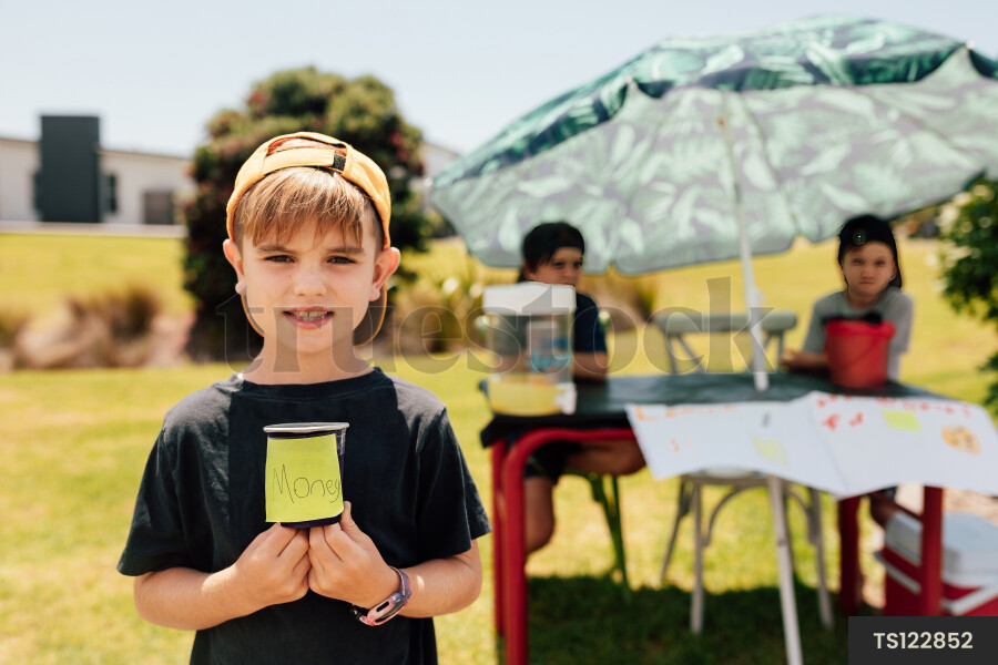 Portrait of Young Boy in Front of Lemonade Stand