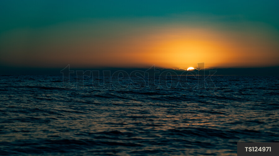 Sunset over sea in Haast