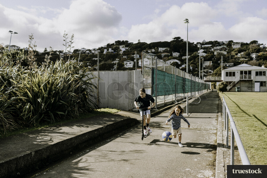 Brothers Playing with Basketball and Scooter