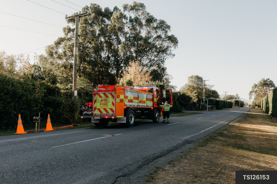 Firefighter and fire engine on road