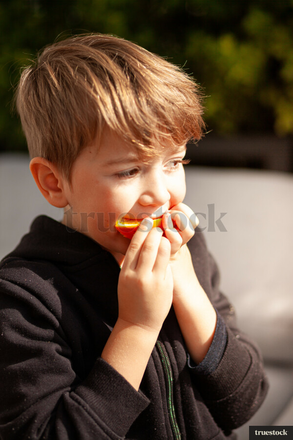 Boy eating a mandarin