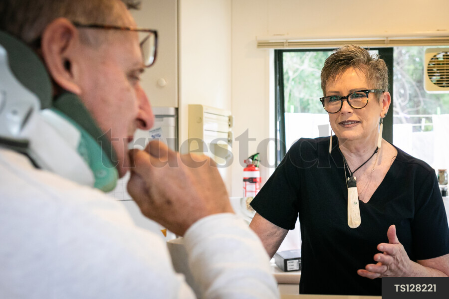Health carer and patient in kitchen