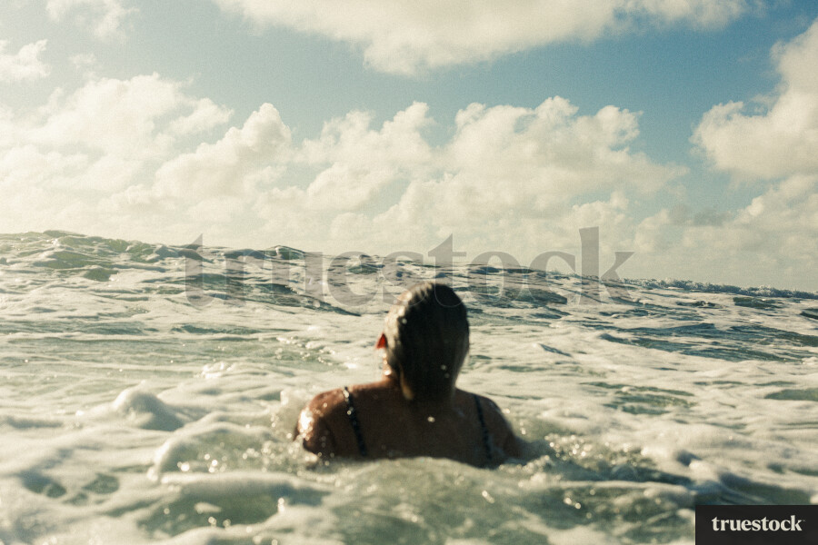 Woman Swimming at Piha Beach