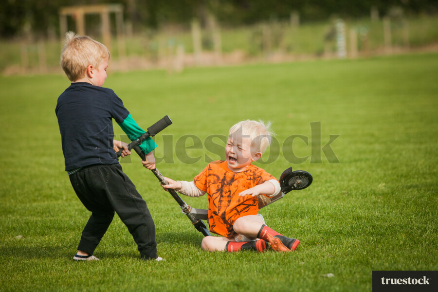 Children fighting over a scooter