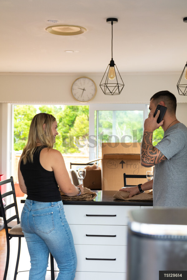 Couple packing in kitchen