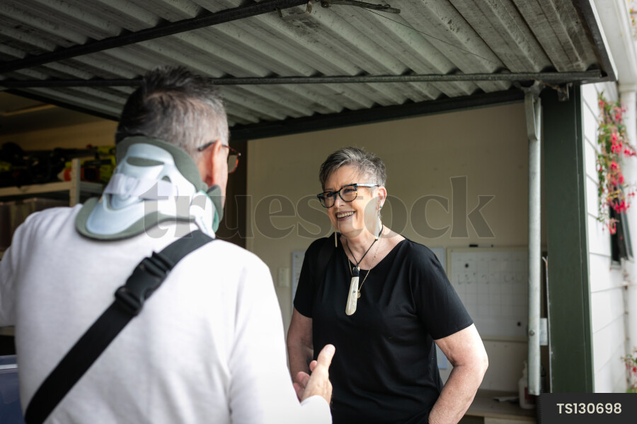 Health carer with patient in garage