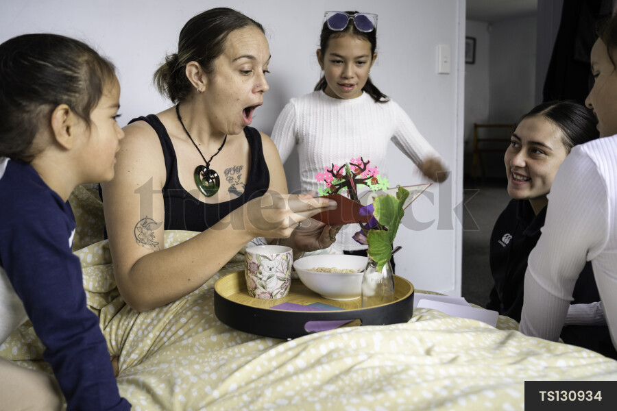 Children with breakfast and card for their mother on Mother's Day