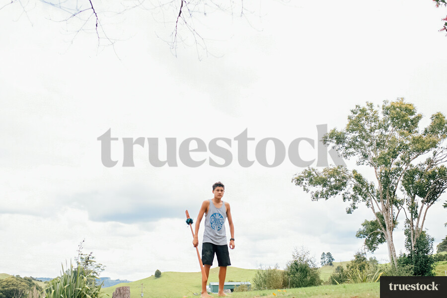 Teenager doing Taiaha in his Backyard