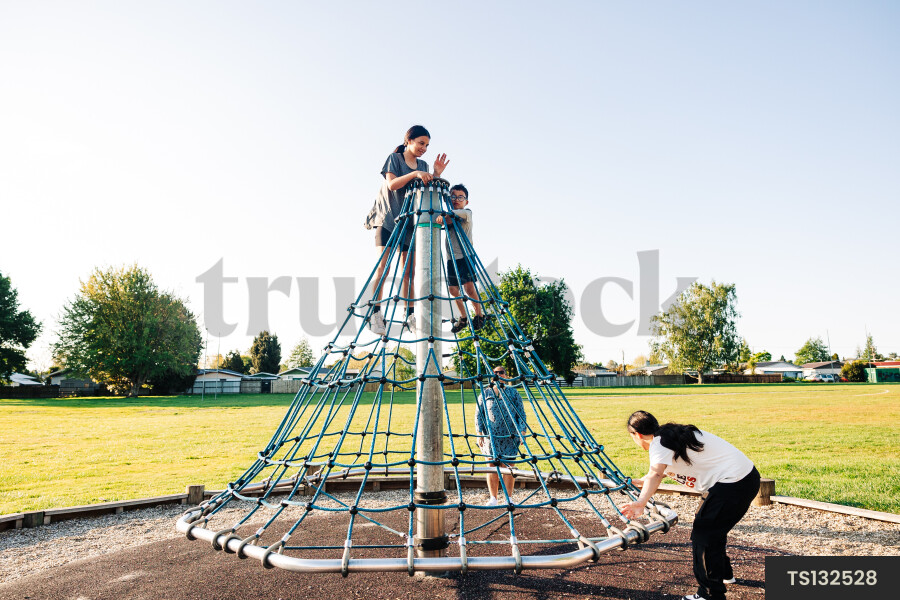 Children climbing jungle gym in park