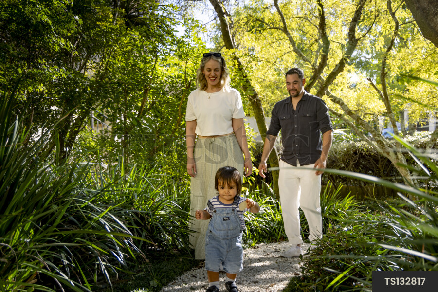 Happy parents walking behind son in park