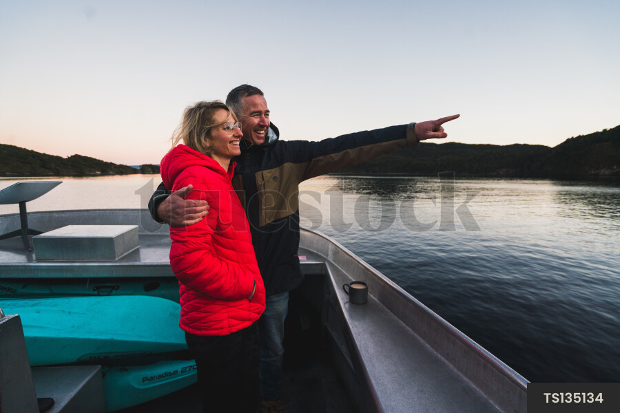 Couple on boat at sunset