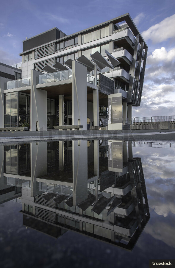 Reflection of apartment building in the water on the concrete