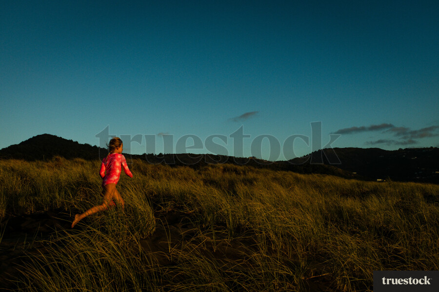 Girl Running in Grass