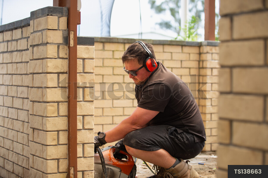 Builder working with tool on construction site