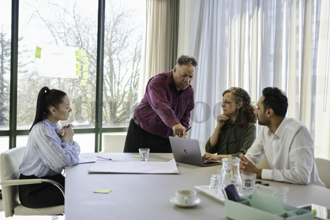 Colleagues Have Discussion in Meeting
