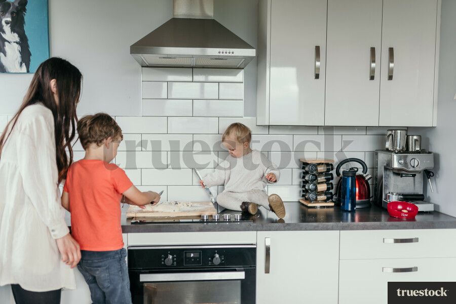 Mother and Kids Baking in Kitchen