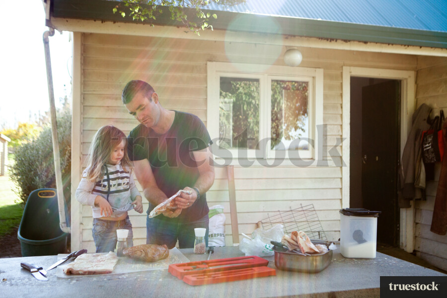 Father Cooking in the Backyard with Daughter