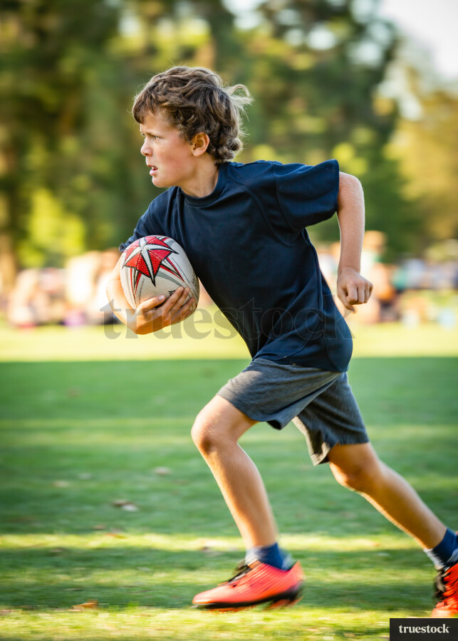 Boy playing rugby