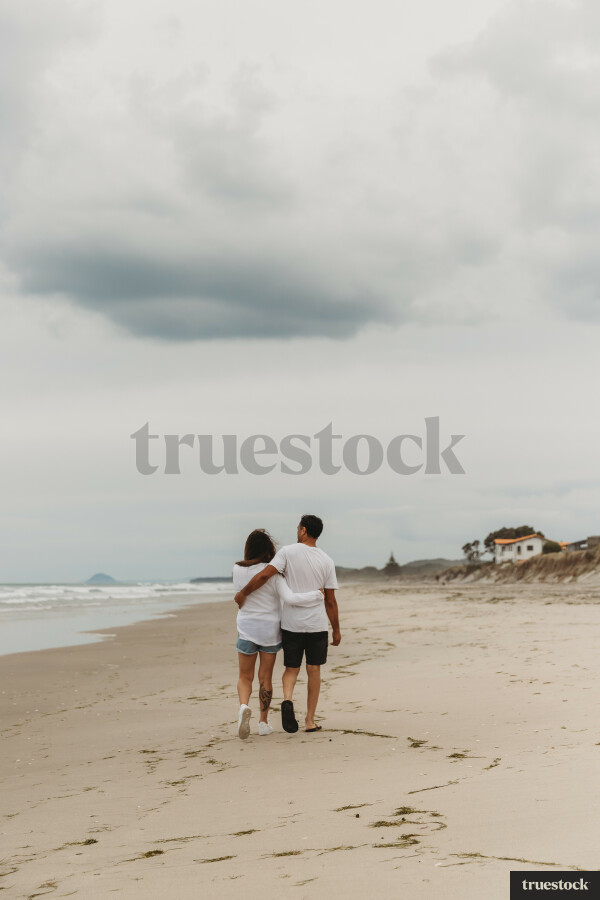 Couple Walking Along The Beach
