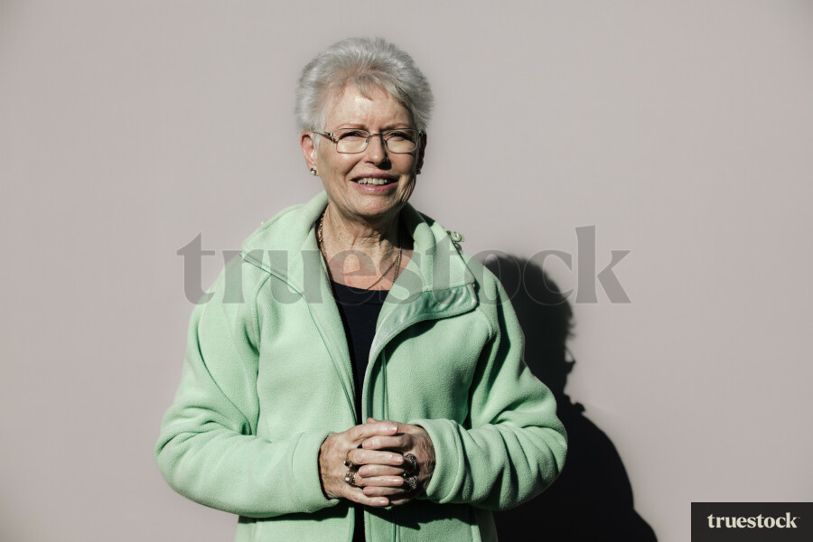 Elderly Māori Woman against a Plain Background