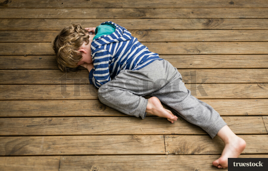 Upset child on wooden deck