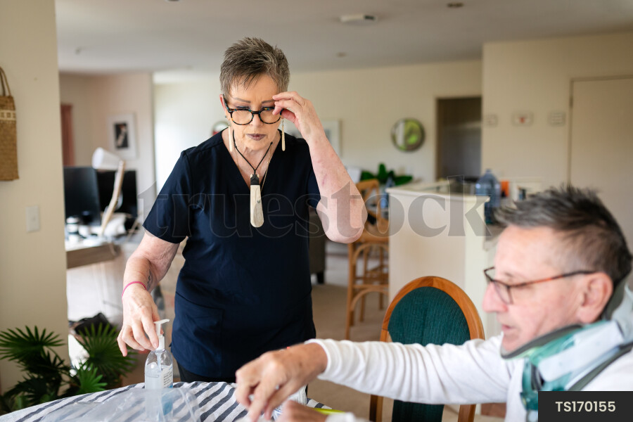 Health carer giving medicine to patient with neck brace