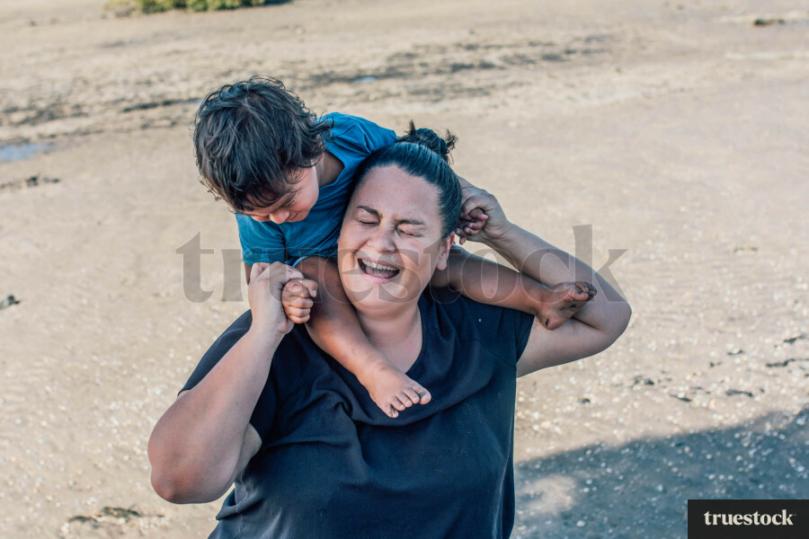 Māmā Playing with her Son at the Beach
