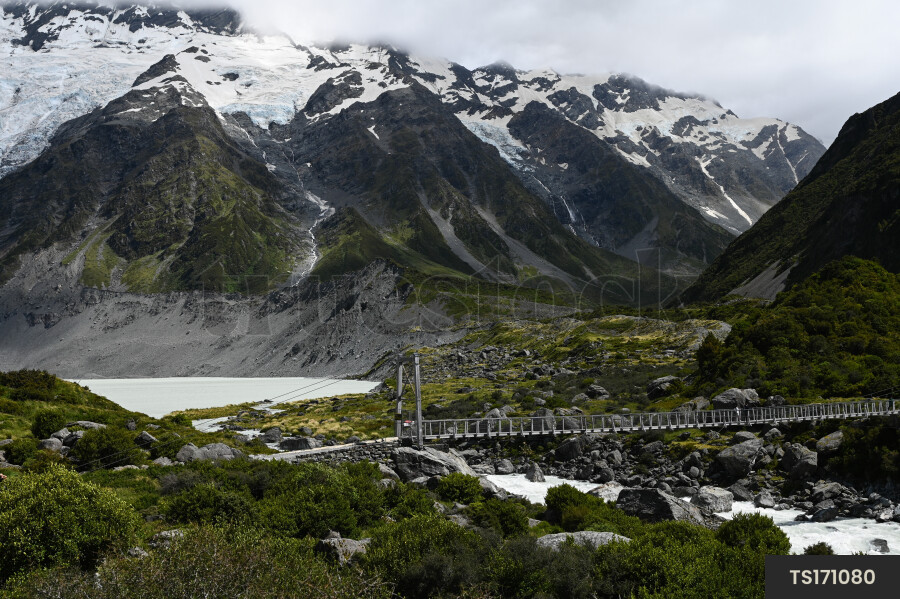 Landscape of bridge over river next to mountain