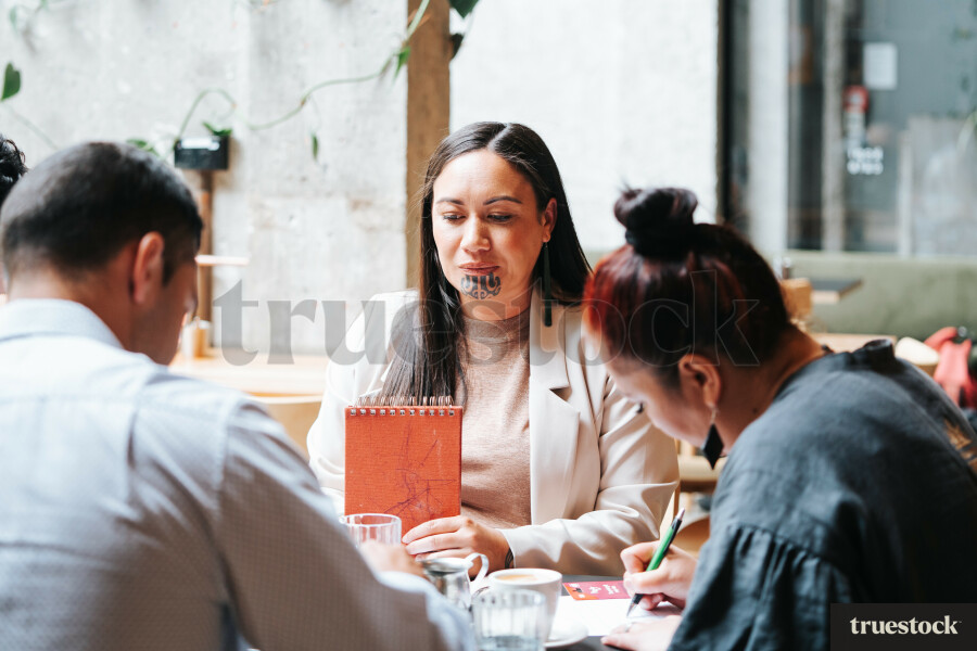 Colleagues Having a Meeting at a Cafe
