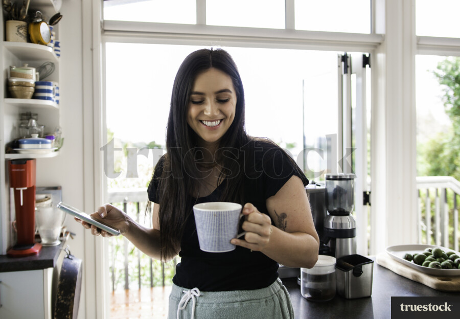 Young Woman on Phone in the Kitchen