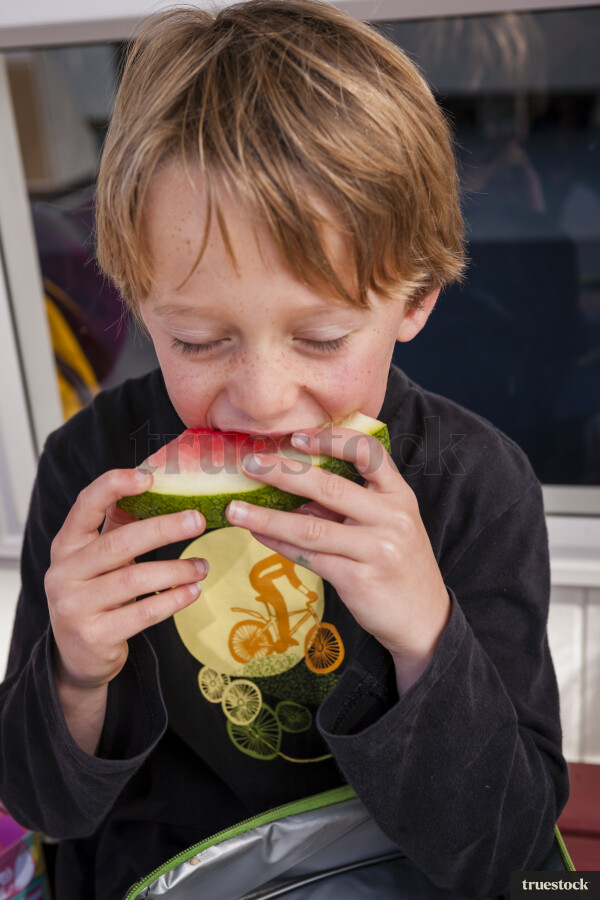 Young Boy eating Watermelon