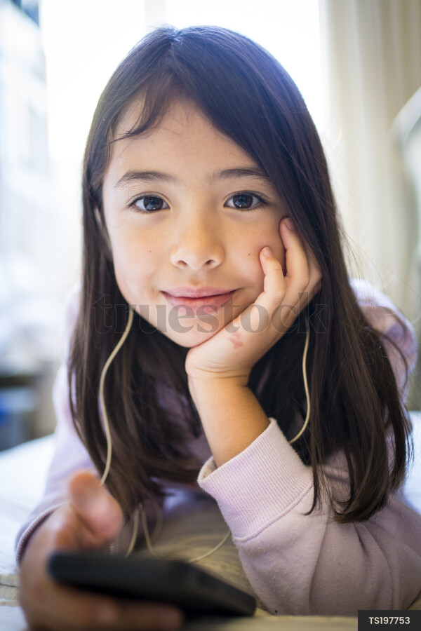 Portrait of girl with cell phone and headphones