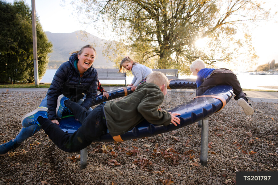 Family playing on playground equipment