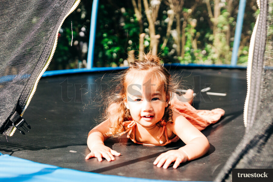 Māori girl playing on the trampoline