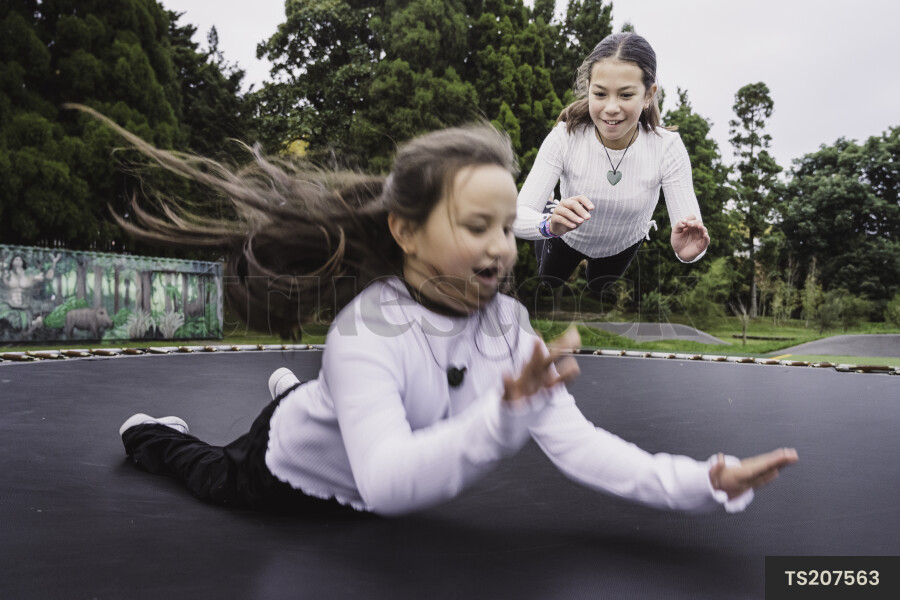 Girls playing on trampoline