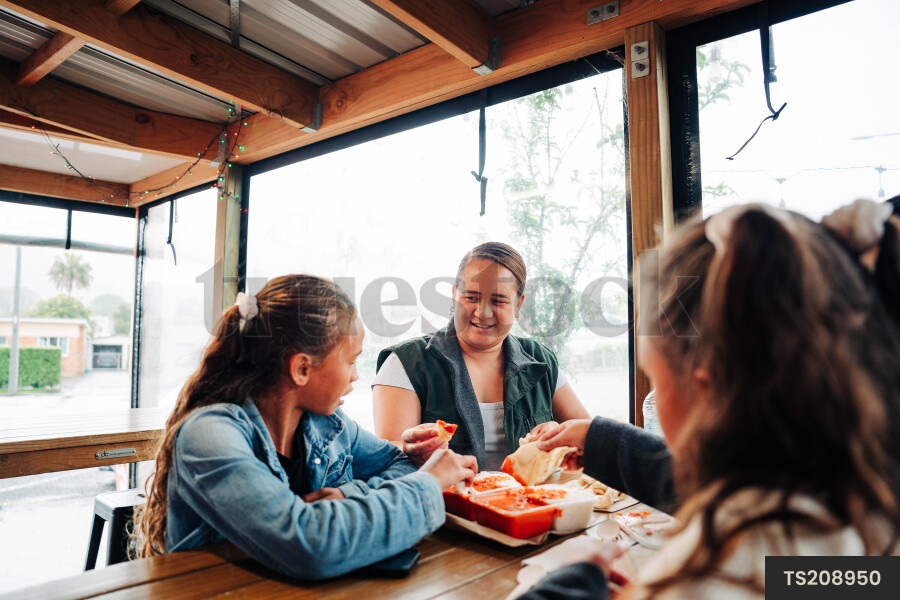 Family sitting at table in restaurant