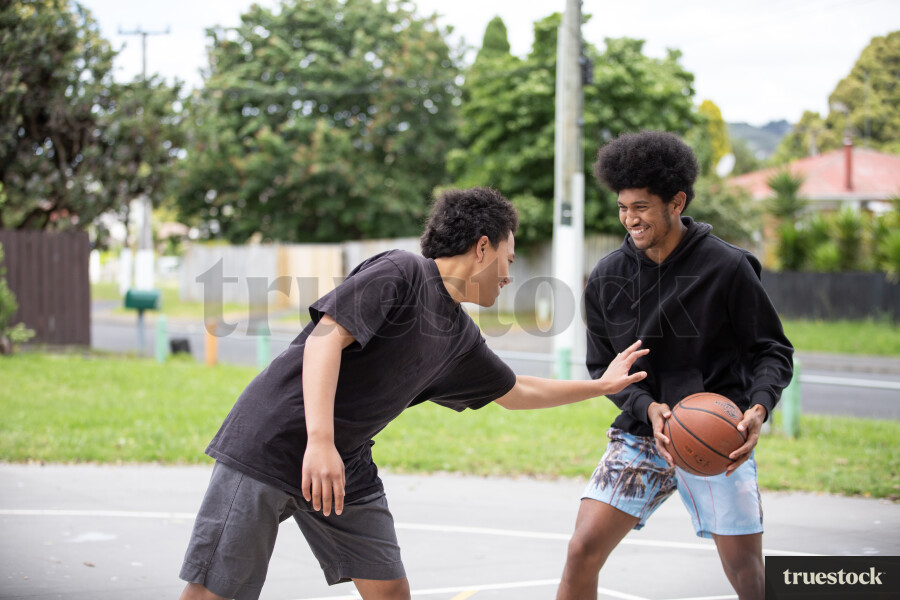 Friends Playing Basketball at Park