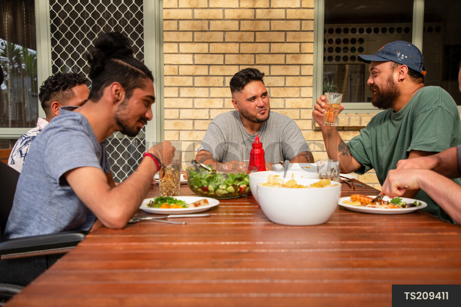 Friends having barbecue dinner