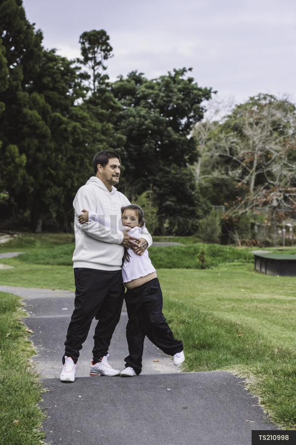 Girl hugging father in park