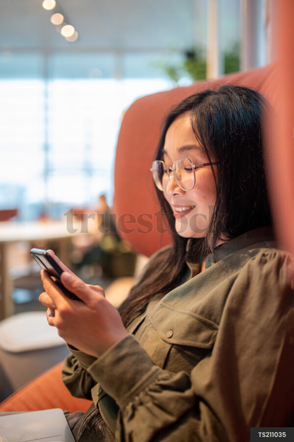 Woman Using Phone at Work