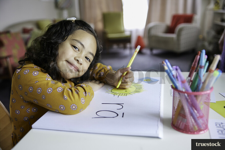 Young Girl Drawing at Home