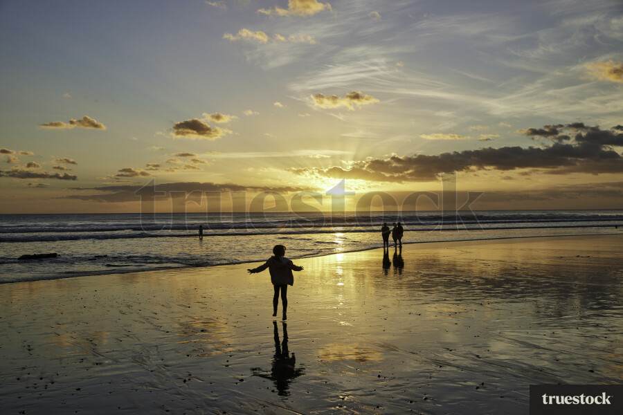 People on Beach at Sunset