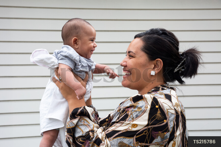 Happy tongan mother holding baby boy