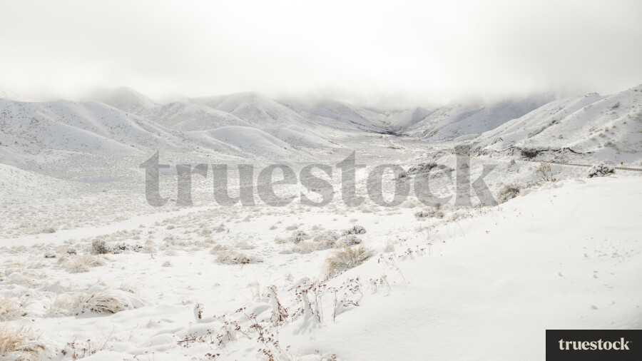 Mountains and road covered in snow